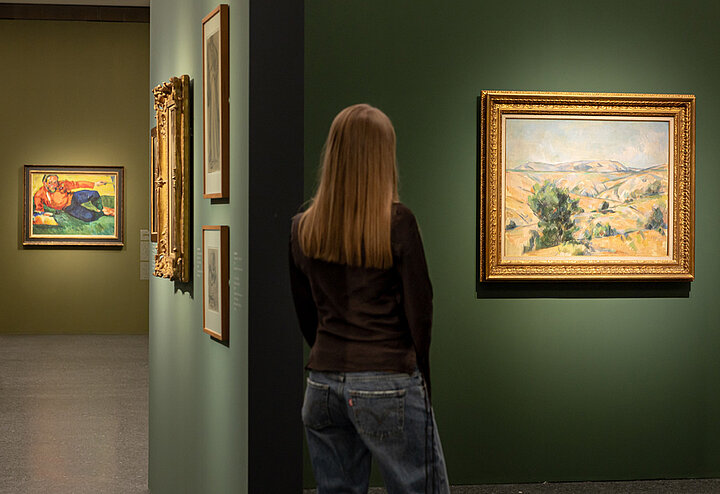 Auf dem Bild sieht man eine Person in der Ausstellung Von Monet bis Picasso. Jüdische Kunstsammler:innen in Deutschland